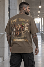 Rear three-quarter view of a tattooed model wearing the T3 The Super taupe tee with the full The FOMO Horsemen back print and small REKTWEAR sleeve badge.